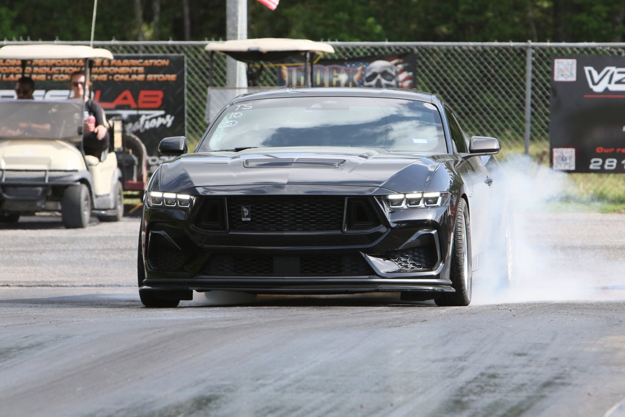 High-performance Mustang racing at Mustang Week event.