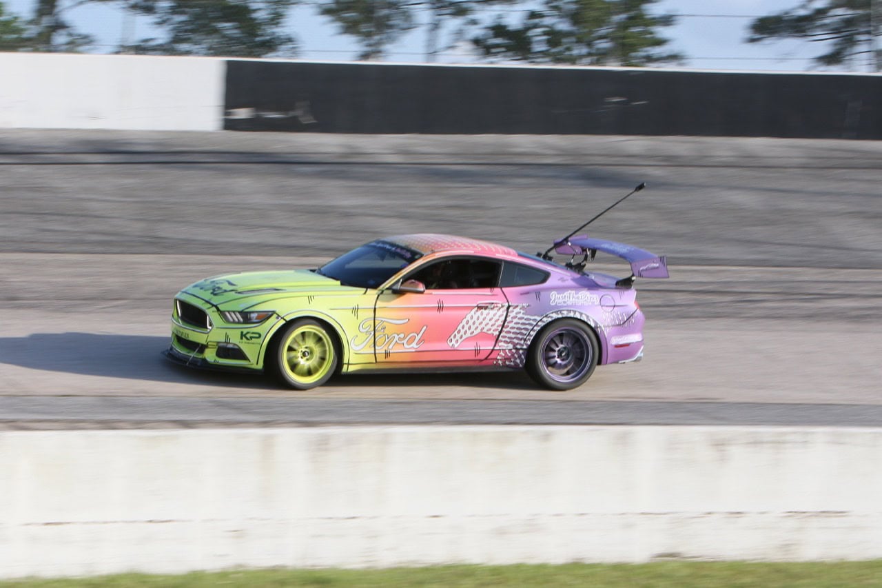 High-speed Mustang race car at Mustang Week event.
