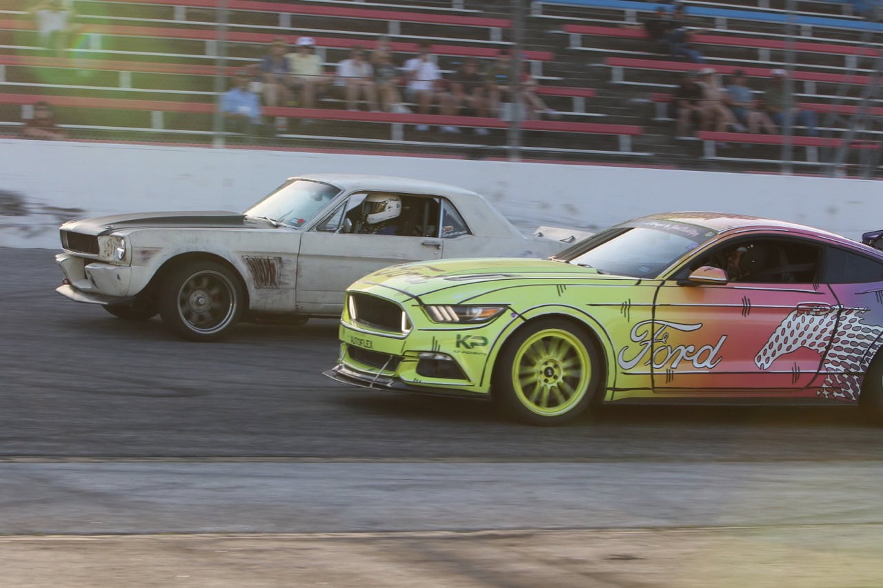 High-speed Ford Mustang racing at Mustang Week event.