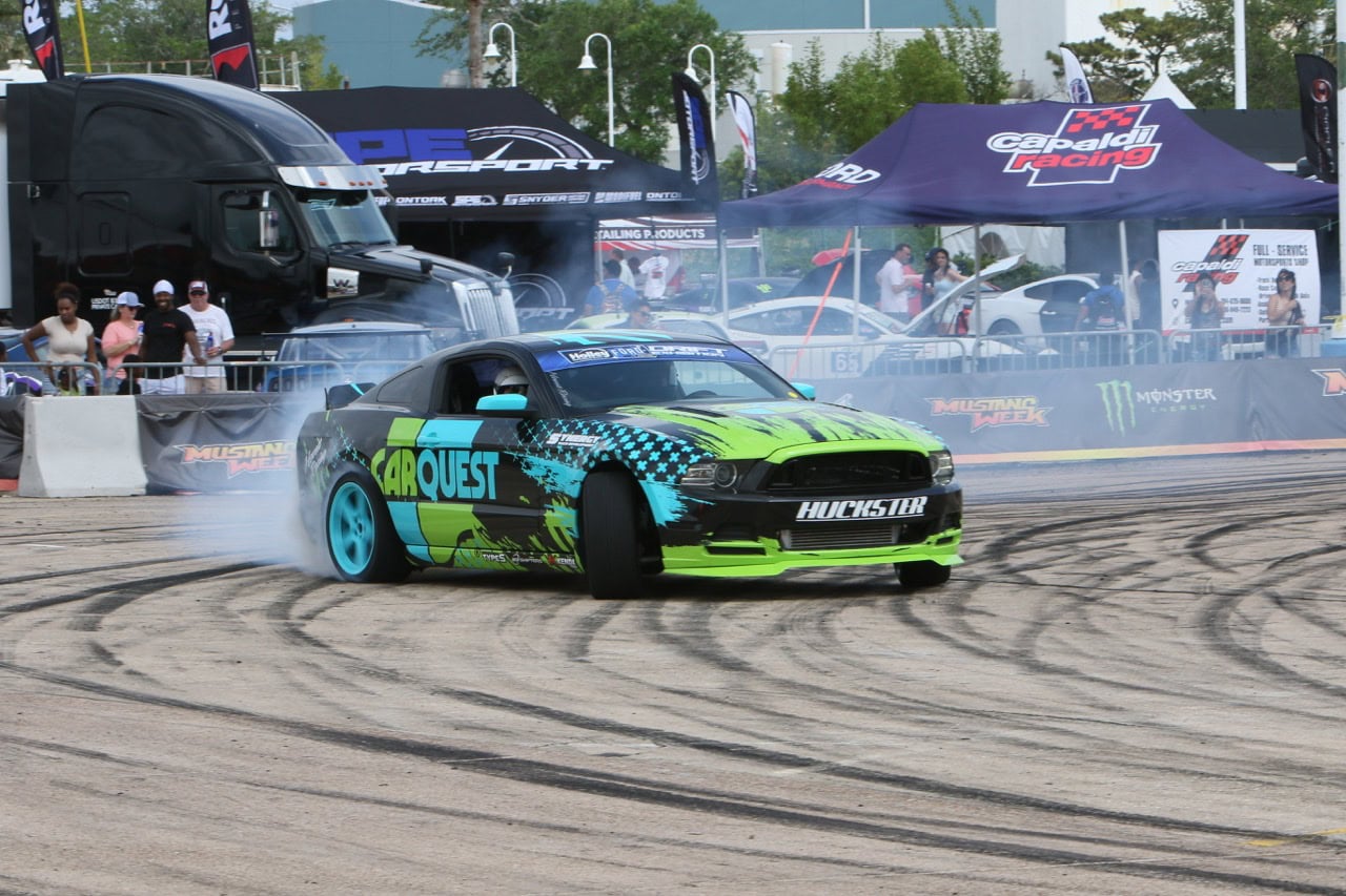 Drift car performing a burnout at Mustang Week event in Texas 2026.
