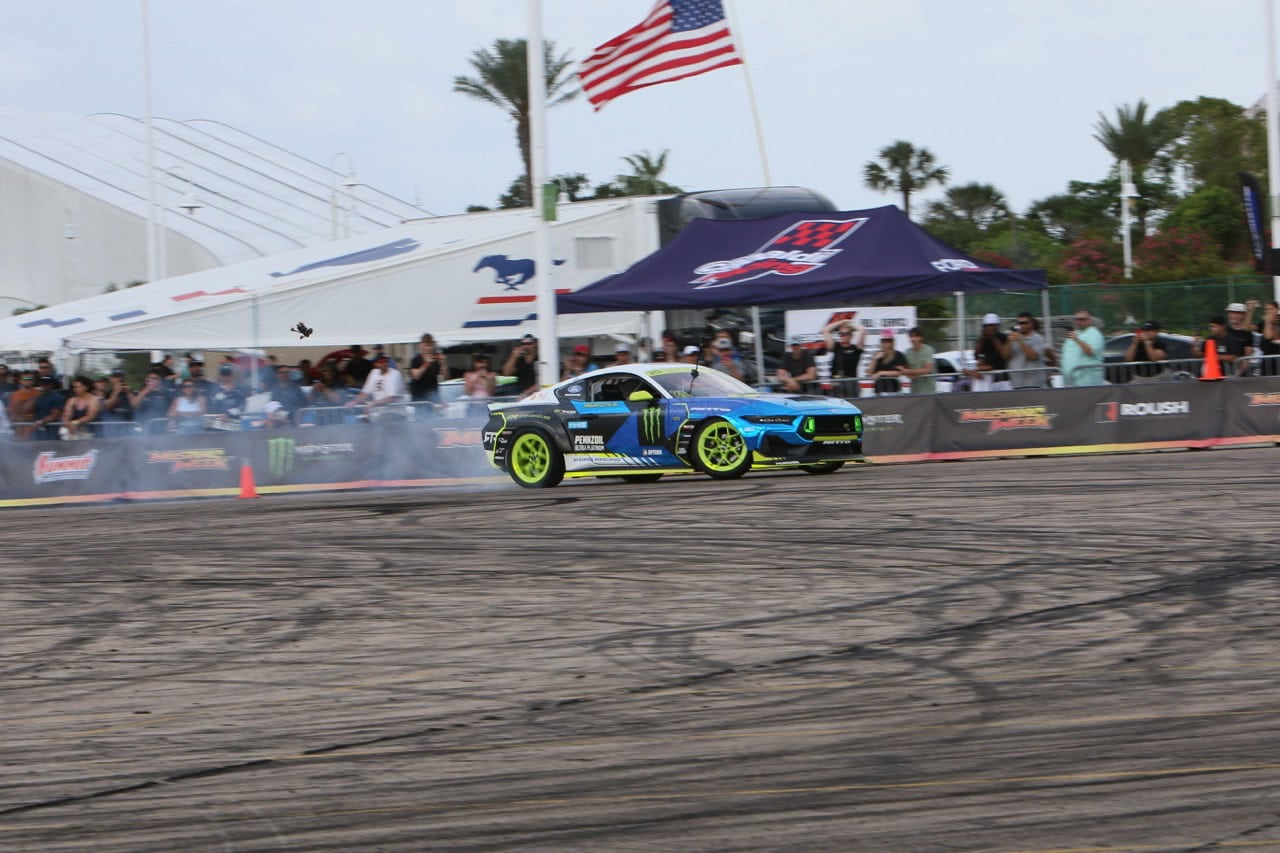 High-performance Mustang drifting at Mustang Week event.