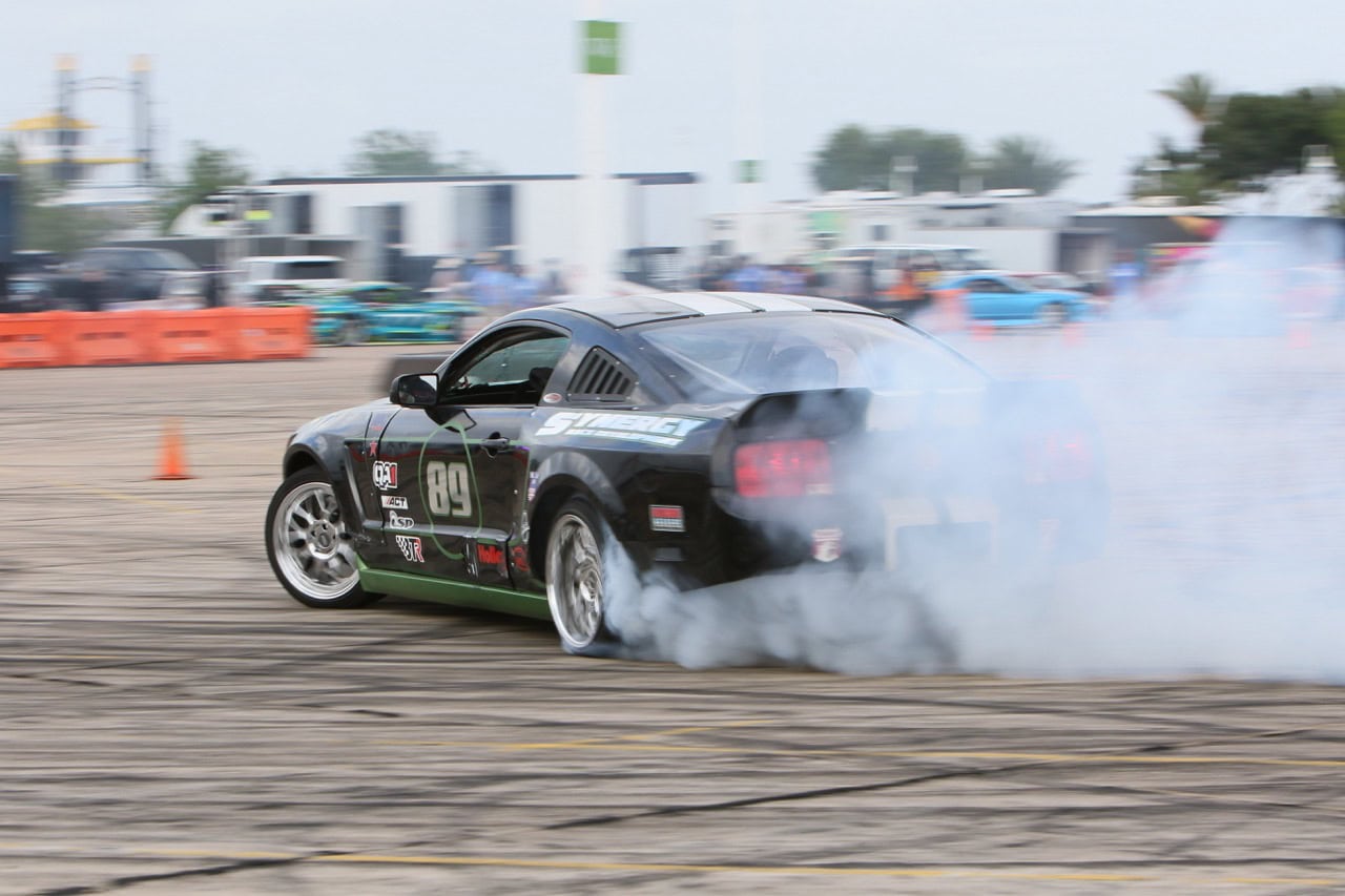 High-performance Mustang drifting at Mustang Week event.