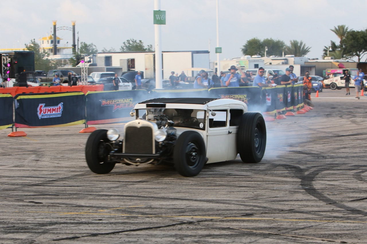 Classic Mustang performing a burnout at Mustang Week event.