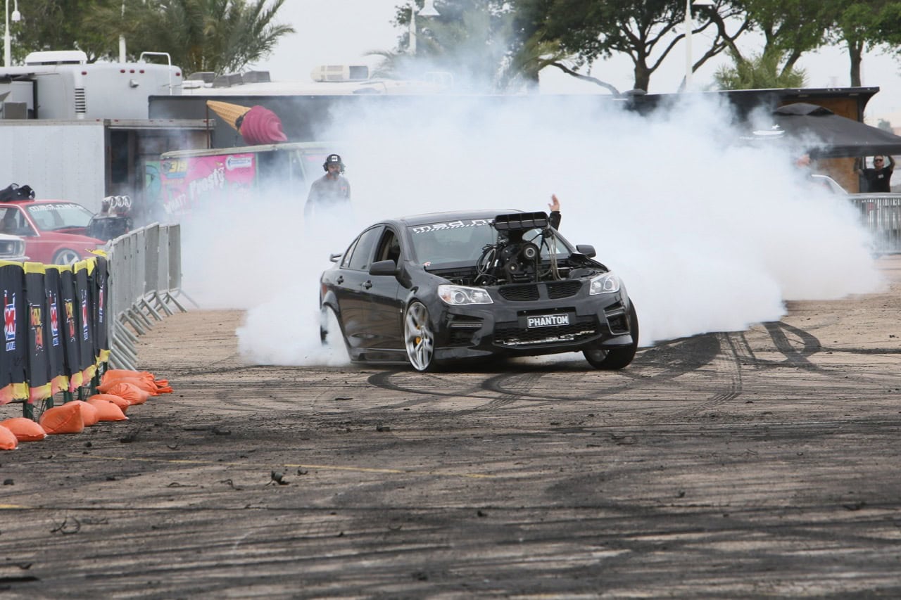 Mustang Week drag racing event with a modified car performing a burnout.