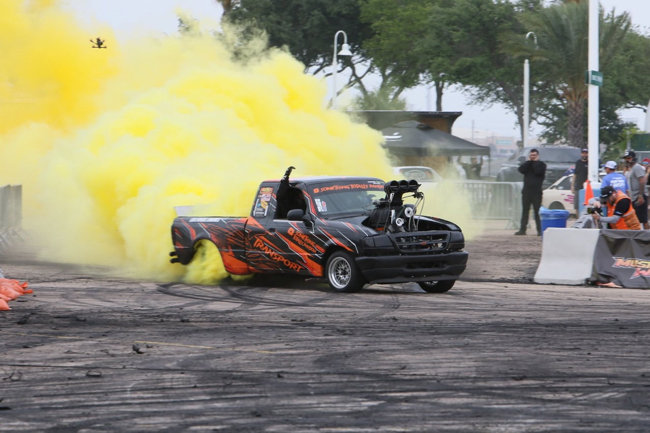Drag racing car performing burnout at Mustang Week.