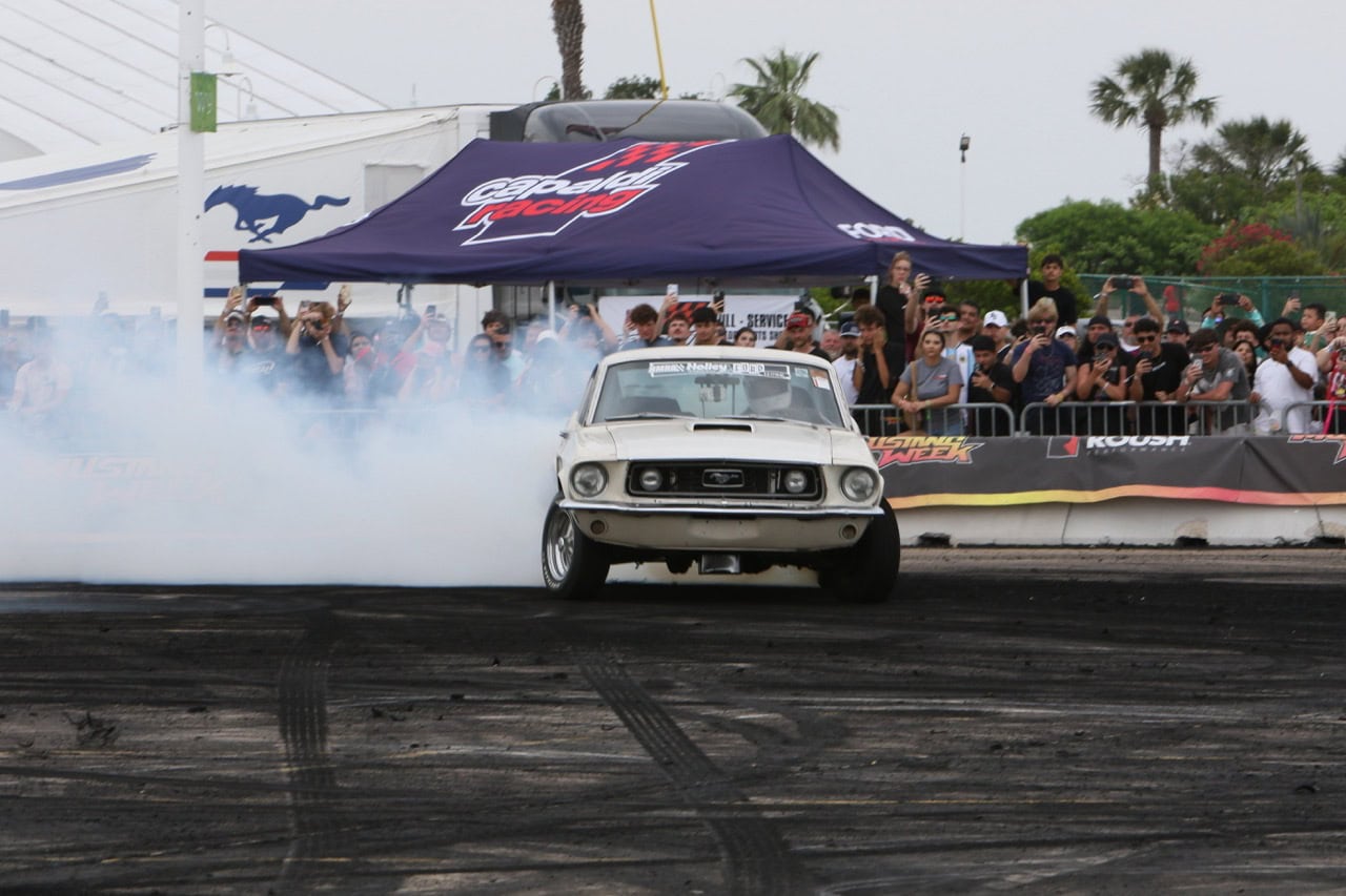 Classic Ford Mustang drifting at Mustang Week event.