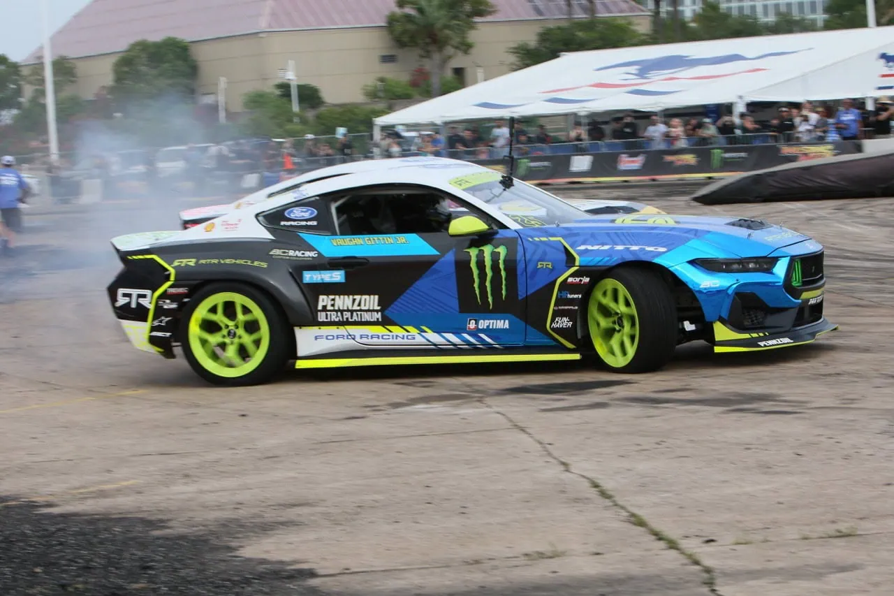 High-performance Ford Mustang drifting at Mustang Week event.