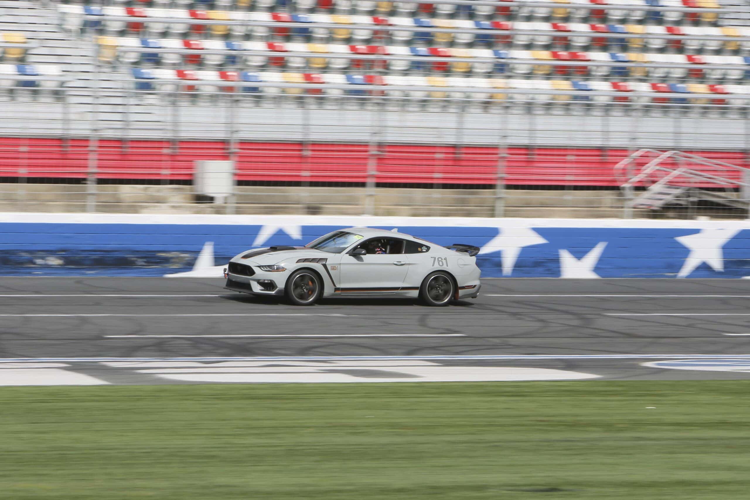 Silver Mustang race car on track at Charlotte 2026 event.