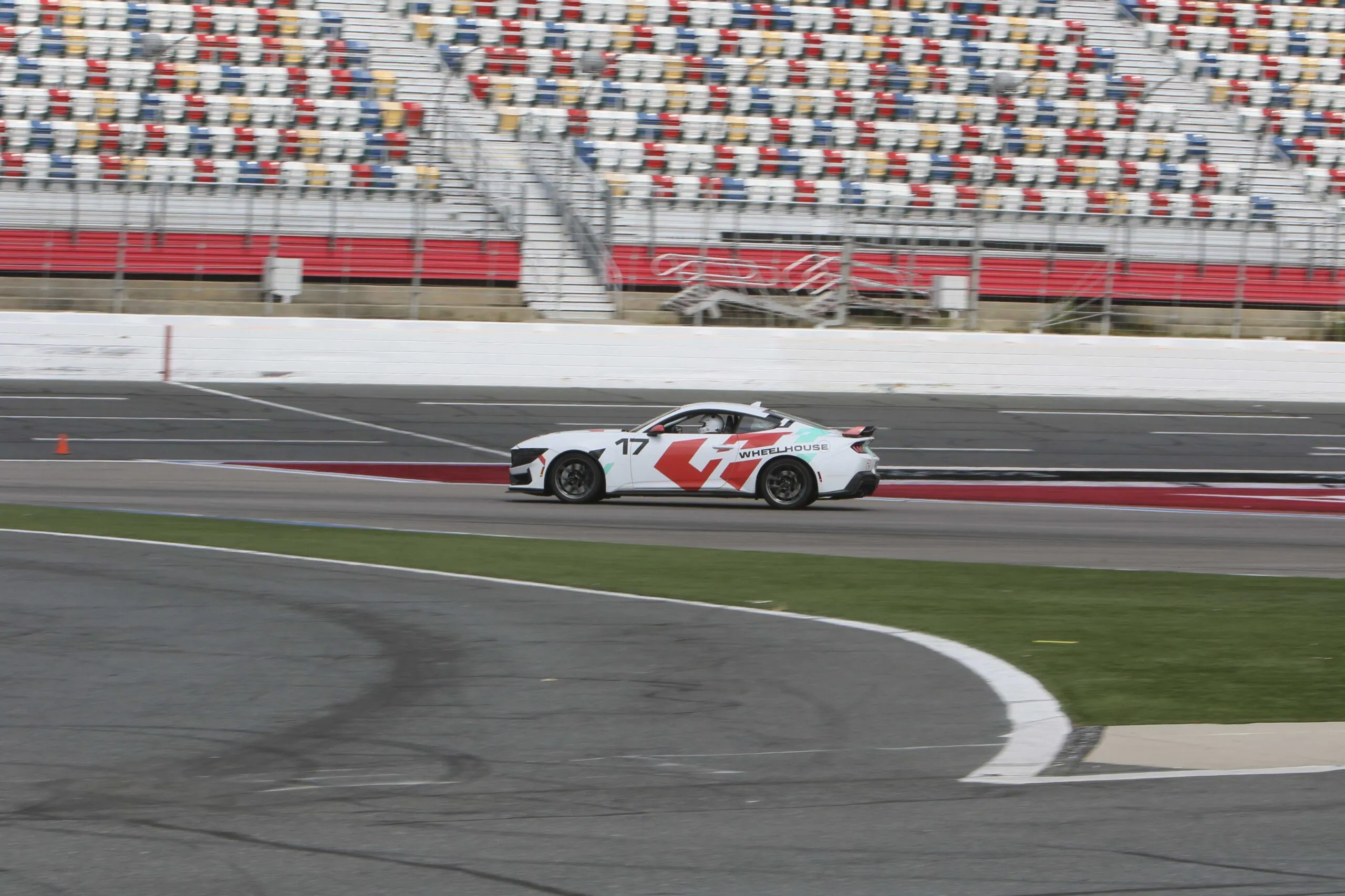 Race car on track during Mustang Week at Charlotte 2026 event.