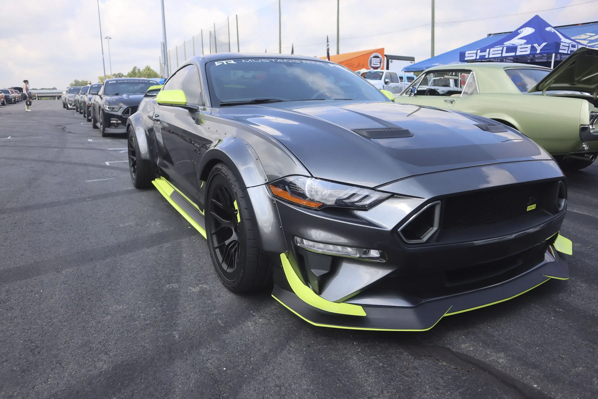 Black and neon green custom Ford Mustang at Mustang Week event.