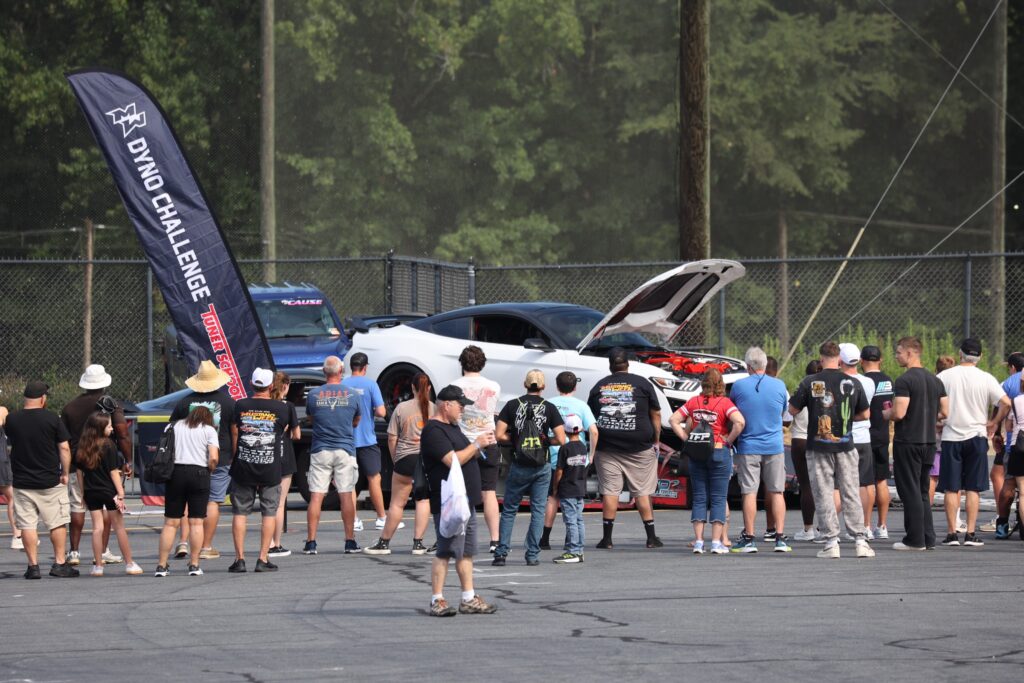 Car show at Mustang Week Charlotte 2026 with crowd and award-winning vehicles.
