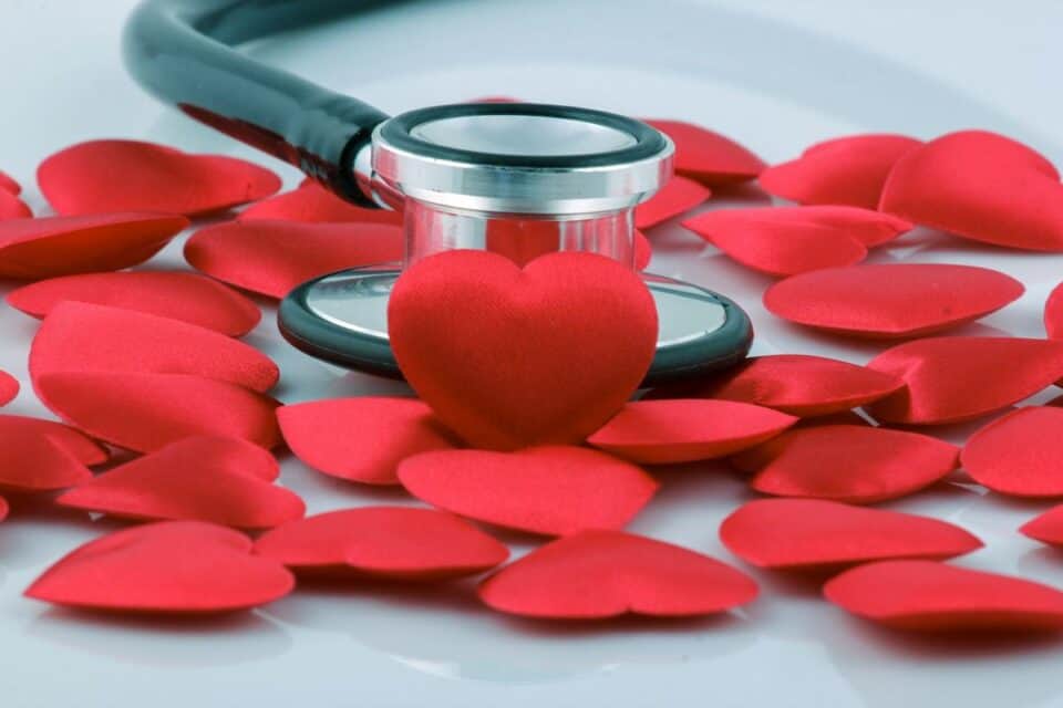 stethoscope with cartoon red hearts around it