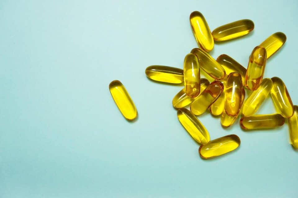 glucosamine pills on top of a blue desk