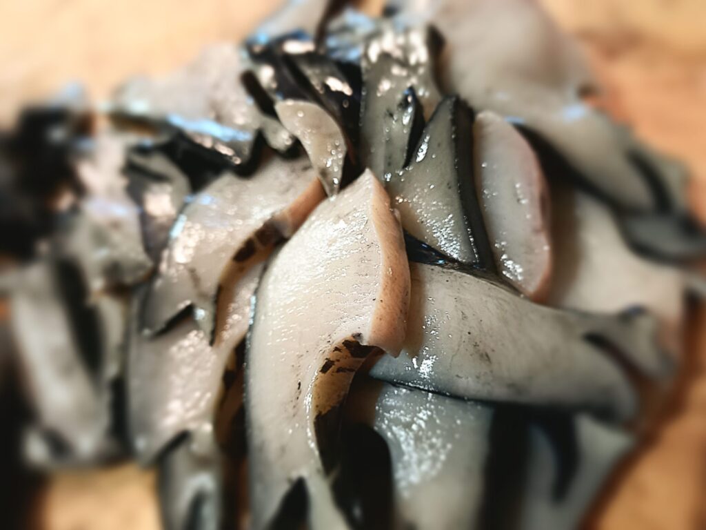 sliced paua on a chopping board