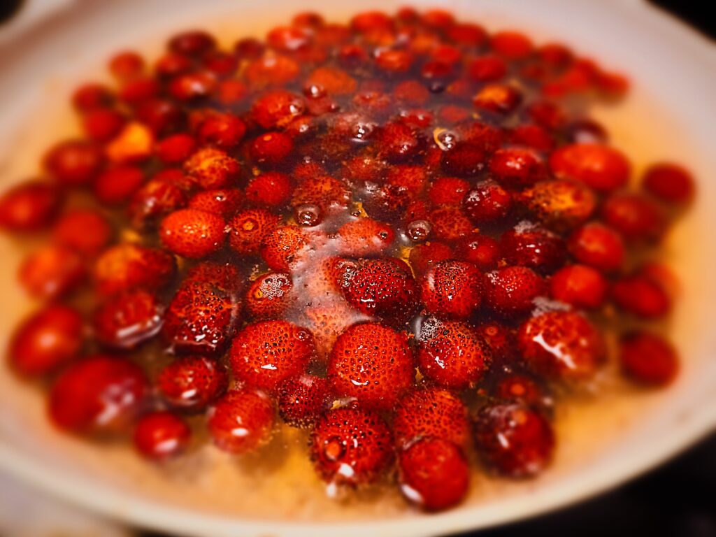 strawberry tree fruit covered with water in a saucepan