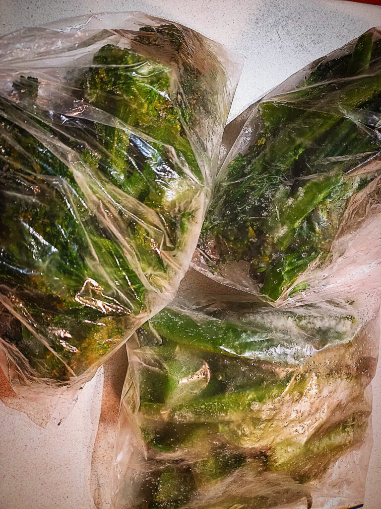 3 clear plastic bags of frozen vegetables