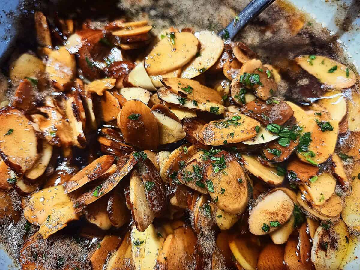 Toasted almonds in a brown butter sauce garnished with finely chopped parsley