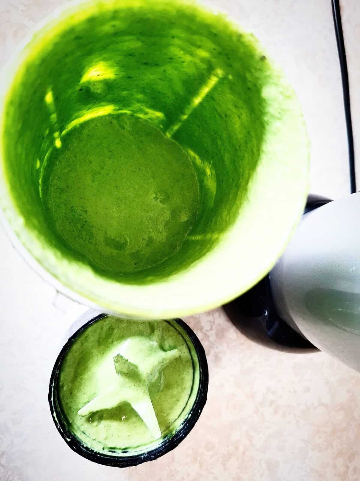 Basil dip in a nutri bullet cup with the blade cap removed showing the dip has been blended until smooth