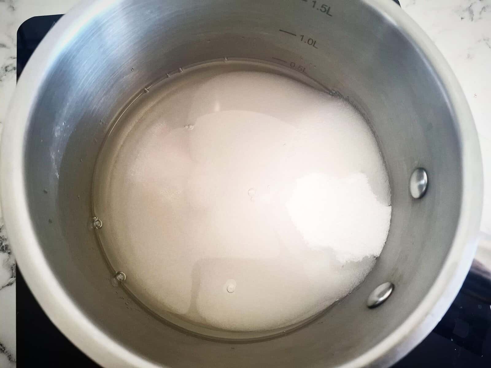 Salt, sugar and rice vinegar in a sauce pan on the stove top