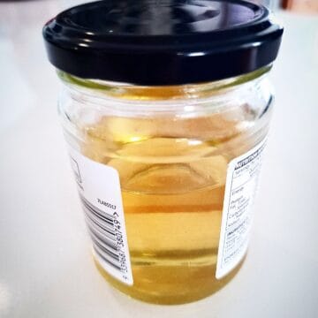 Sushi vinegar in a recycled glass jar on a white table