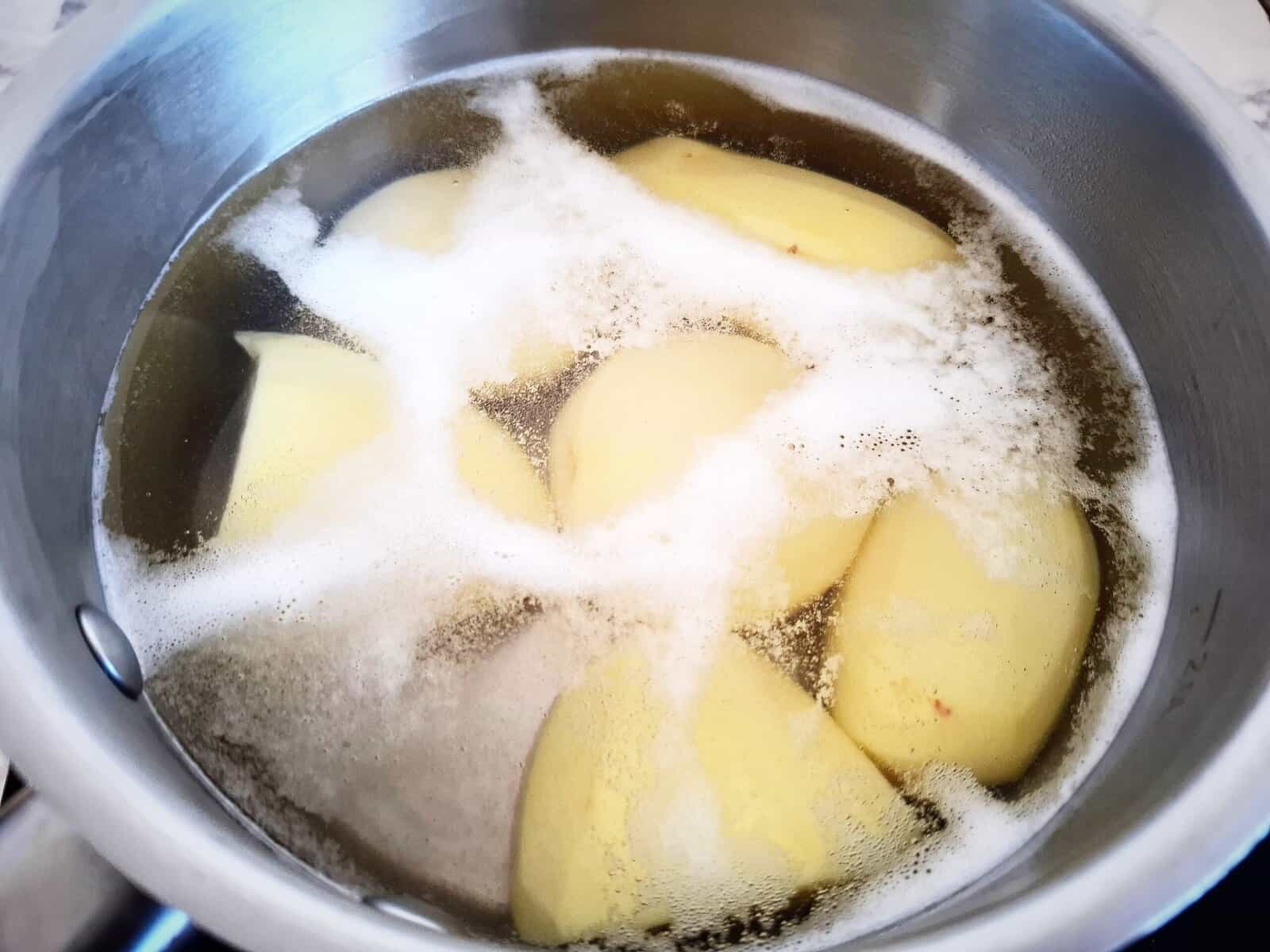 Boiling six peeled potatoes in a saucepan