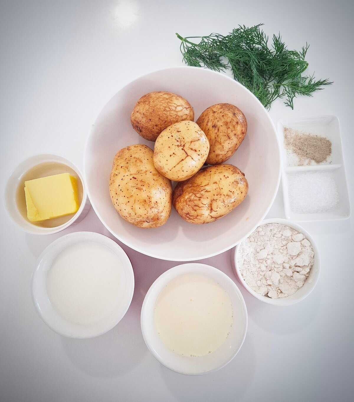All the ingredients for Mediterranean roasted potatoes on a white table