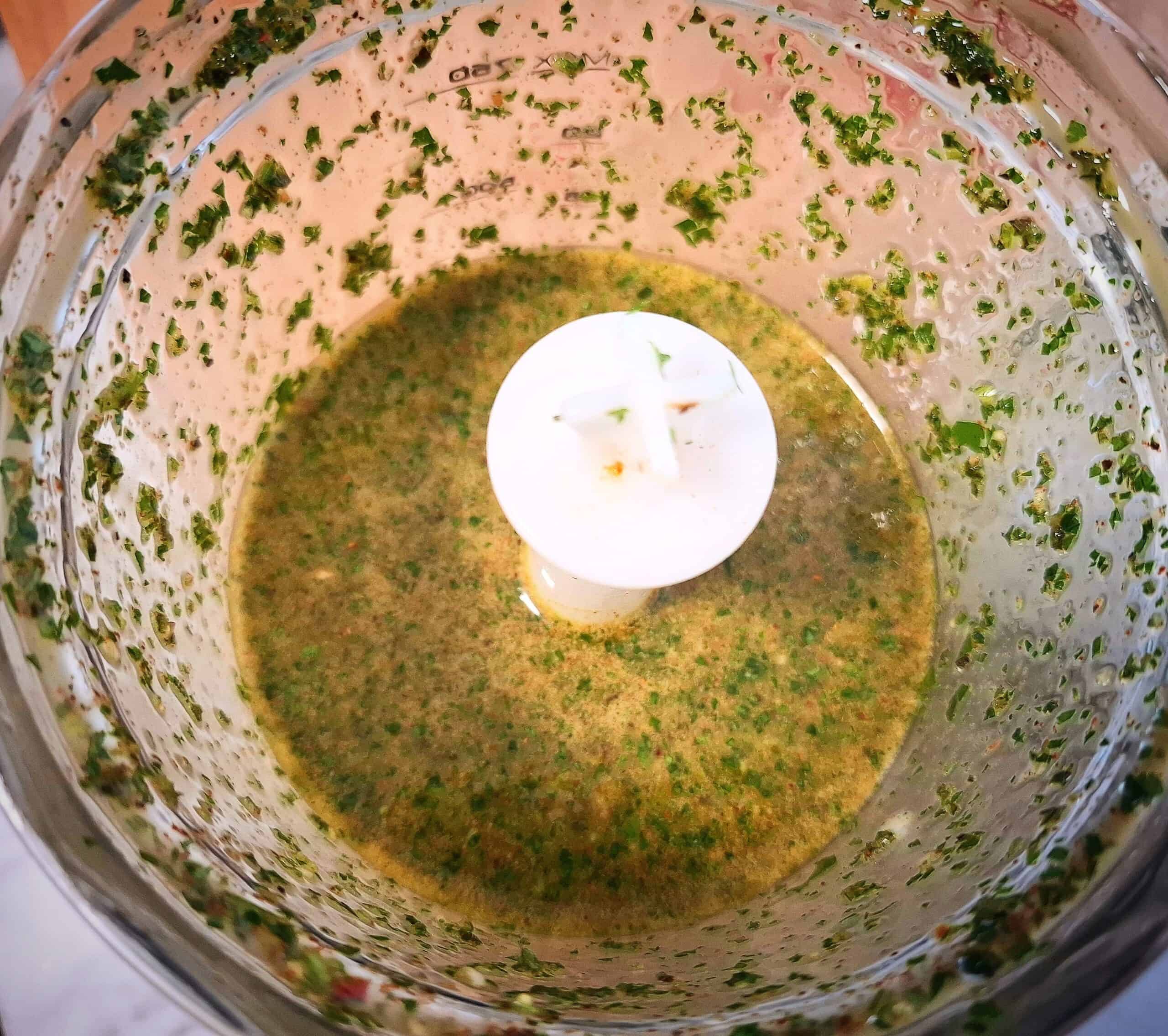Chimichurri sauce red chopped in a clear blender base