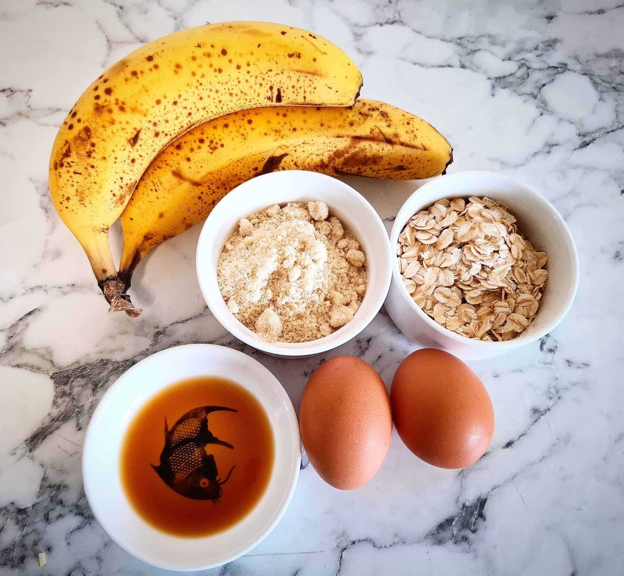 Ingredients for banana pikelets on a marbled bench top.