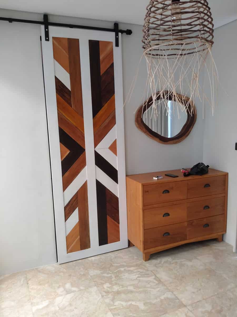 A collection of custom indoor teak furniture, including wardrobes, kitchen sets, and desks, manufactured by Naramulya for the Ketewel project.