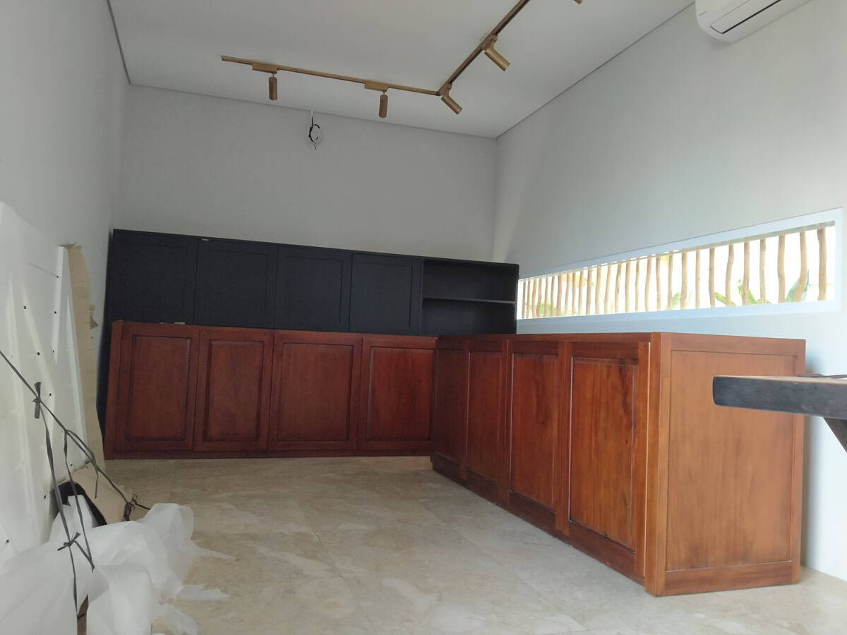 A collection of custom indoor teak furniture, including wardrobes, kitchen sets, and desks, manufactured by Naramulya for the Ketewel project.