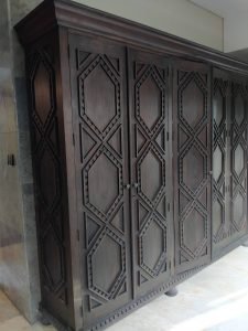 A collection of custom indoor teak furniture, including wardrobes, kitchen sets, and desks, manufactured by Naramulya for the Ketewel project.
