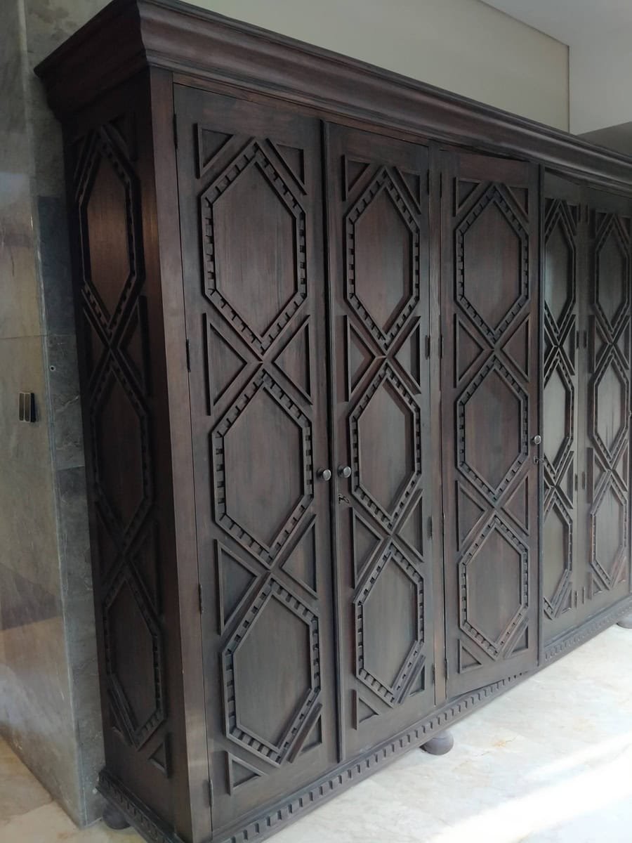 A collection of custom indoor teak furniture, including wardrobes, kitchen sets, and desks, manufactured by Naramulya for the Ketewel project.