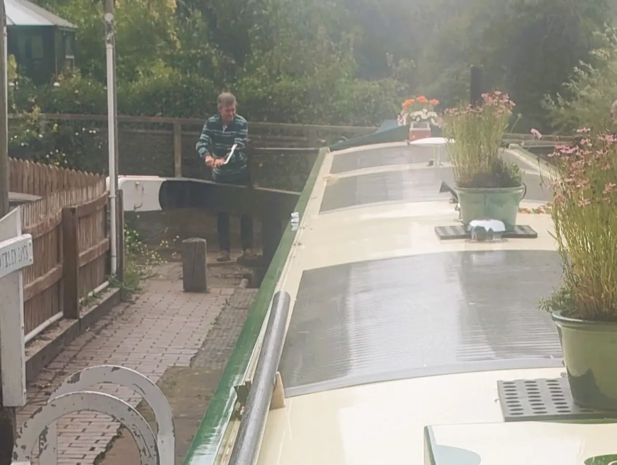 A photo of a man working a canal lock