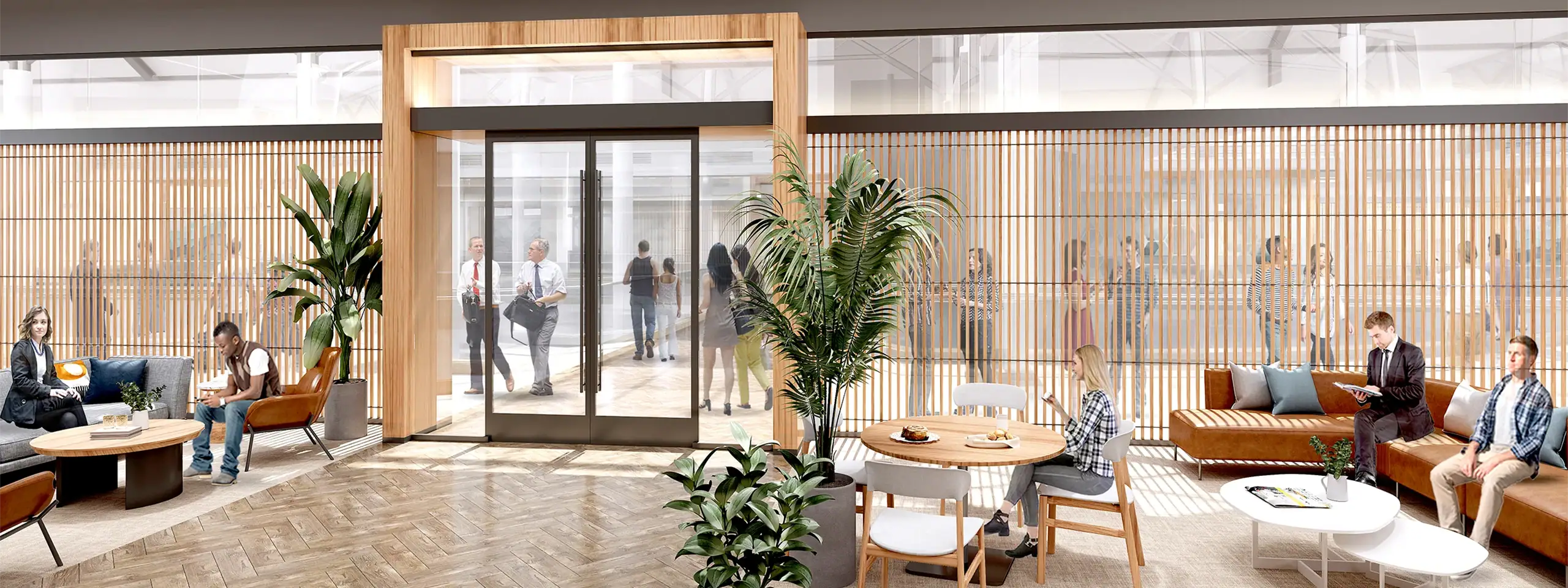 Modern lobby with glass doors, potted plants, and seating areas at New England Development.