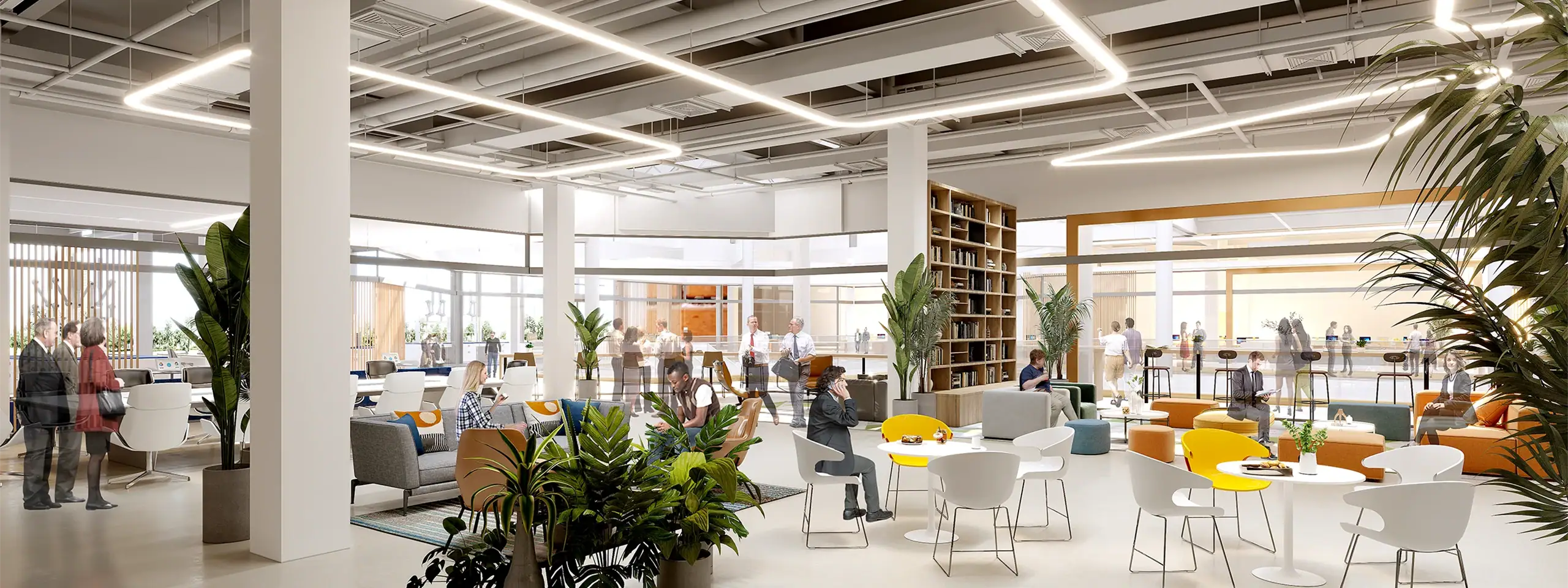 Modern office interior with open workspace, plants, and natural light.