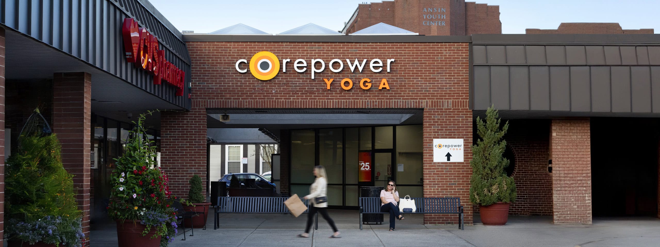 Corepower Yoga studio entrance with brick facade and outdoor seating.