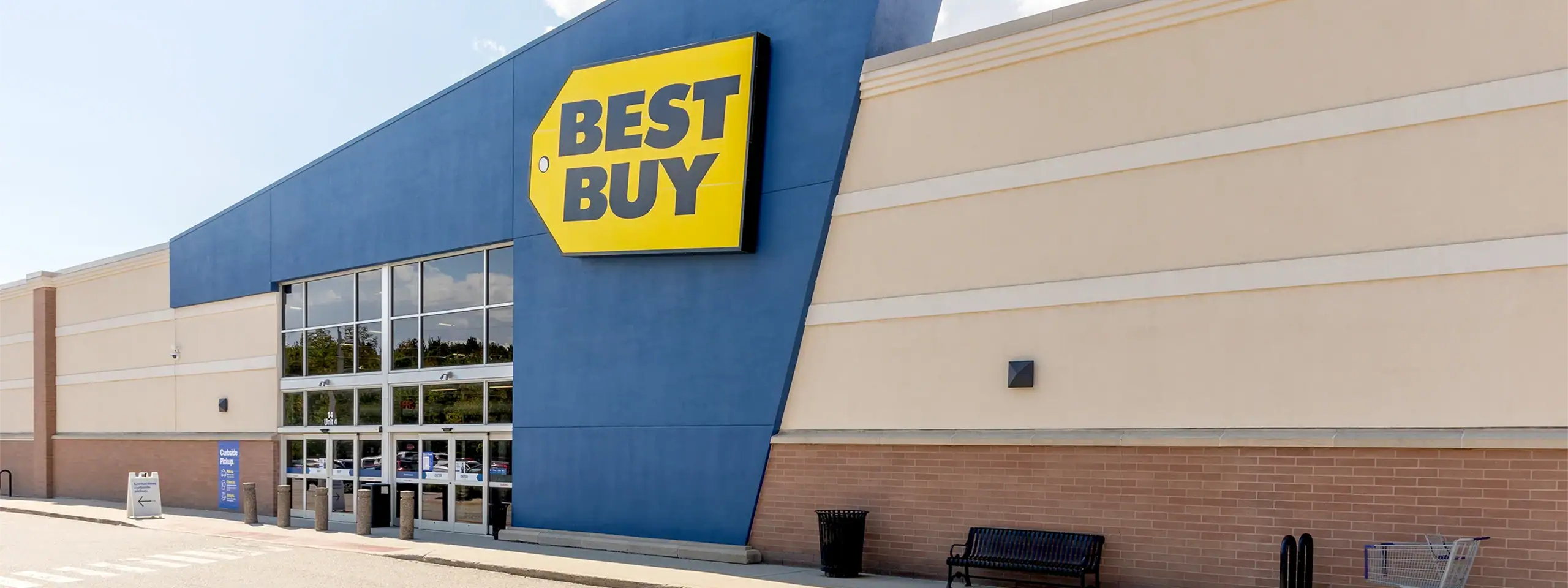 Best Buy store exterior with blue facade and large yellow sign.