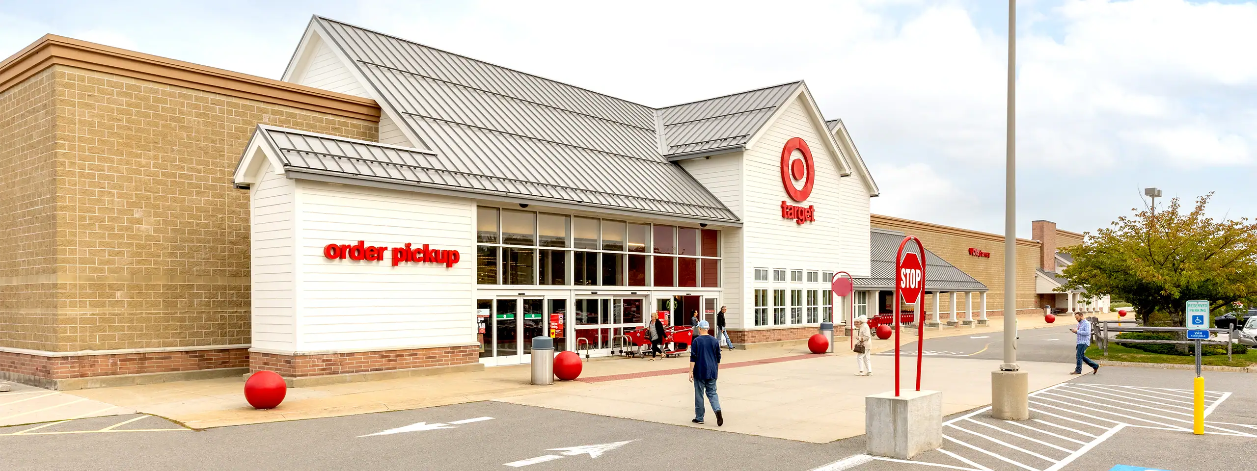 Target store with order pickup area in a shopping center parking lot.
