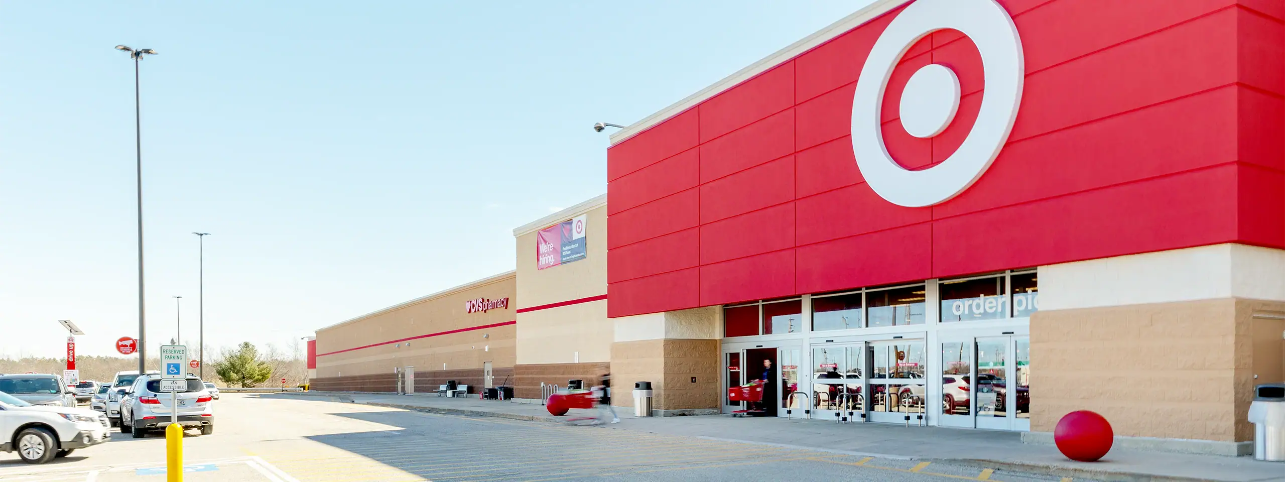 Target store exterior with red logo and shopping carts outside in a parking lot.