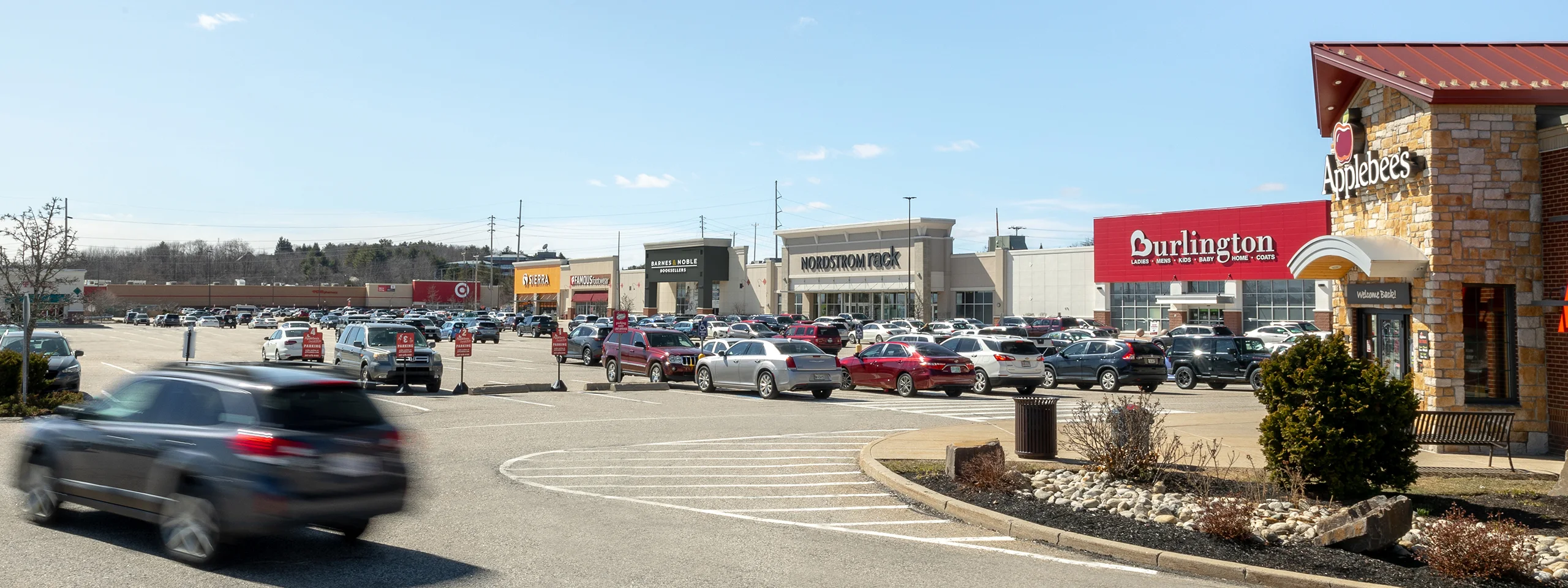 Shopping plaza with parking lot and cars, Burlington, Massachusetts.