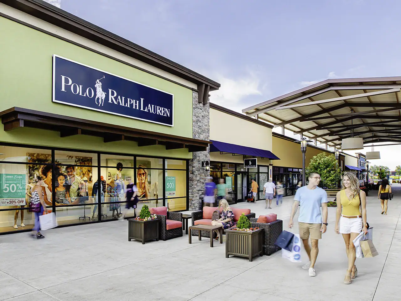 Shopping center with Polo Ralph Lauren store and outdoor seating area.
