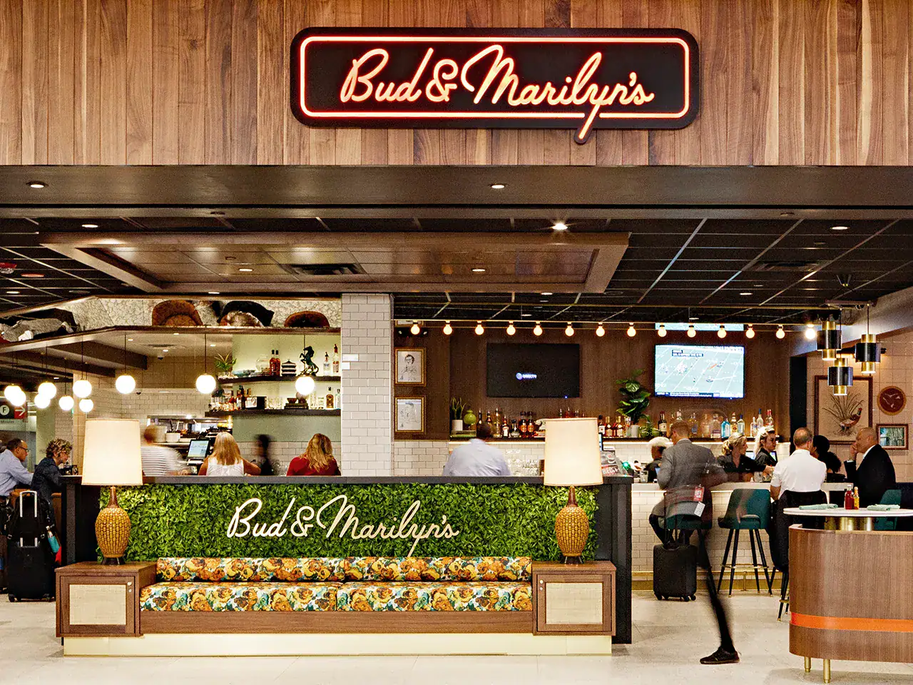 Interior view of Bud & Marilyn's restaurant with patrons dining and a bar area.