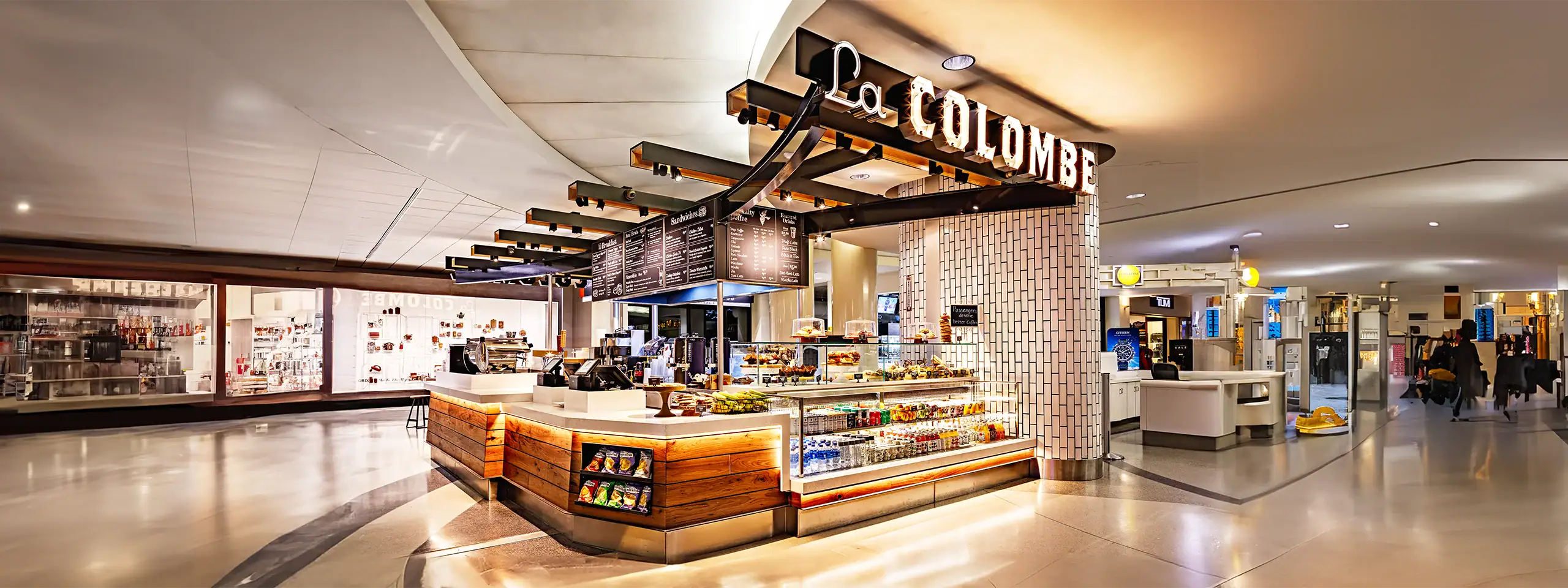 Le Colombe bakery counter inside a modern shopping mall in New England.