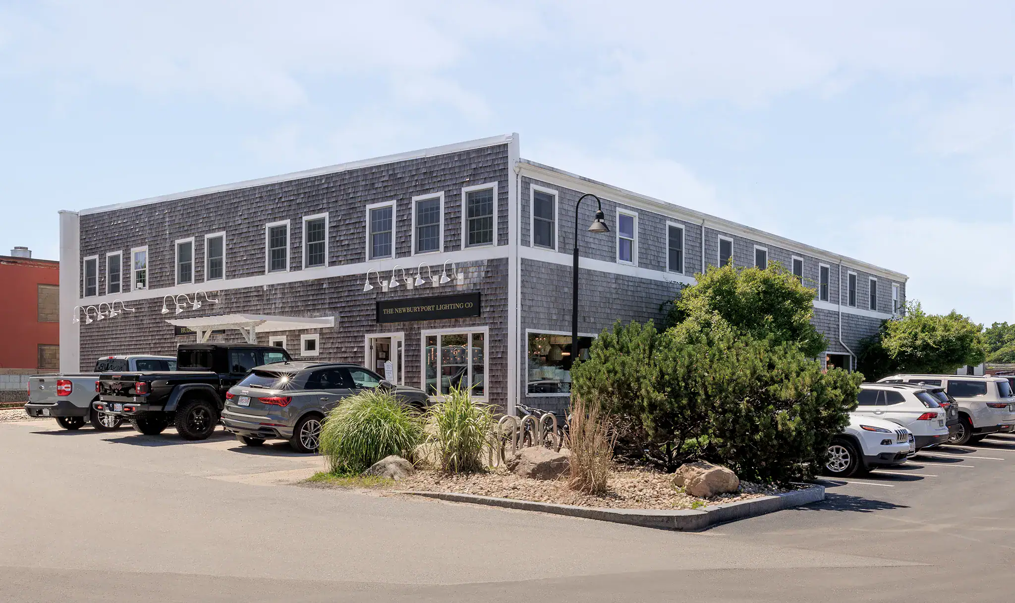 Modern two-story commercial building with parking lot and landscaping in Newburyport.