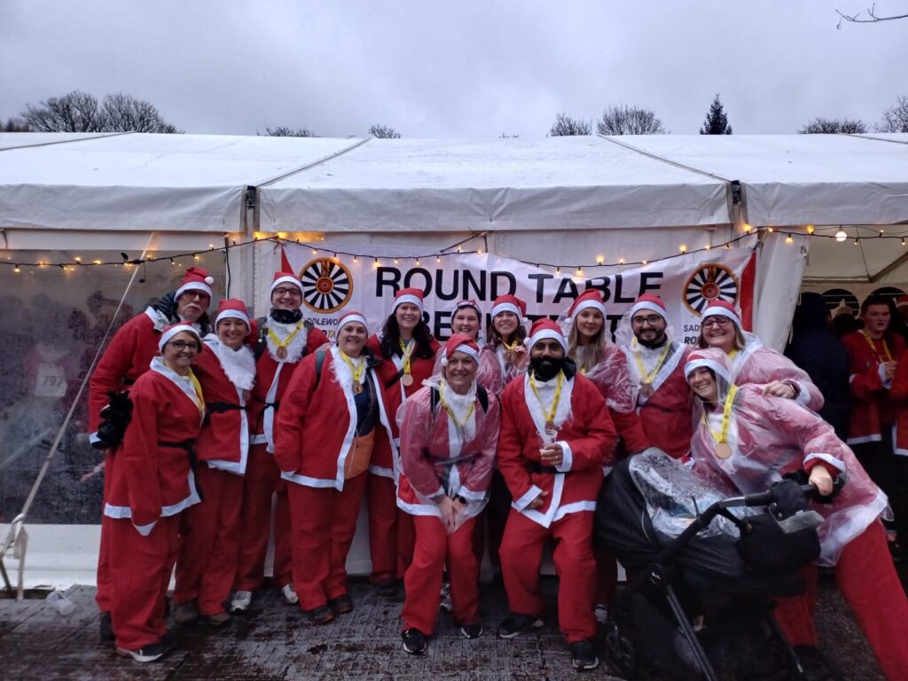 North Ainley sponsors festive Santa Dash event with team in Christmas costumes.