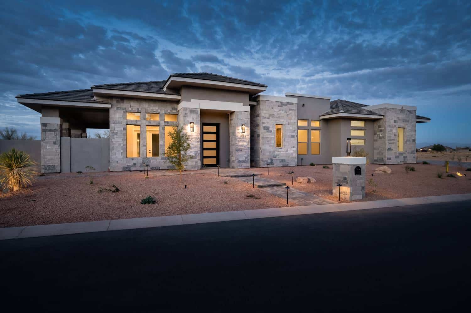 Exterior of gray stone and stucco home.