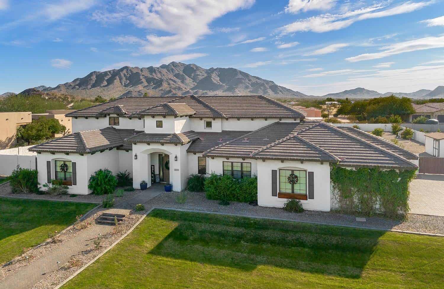 Elegant custom home with desert landscape and mountain backdrop.