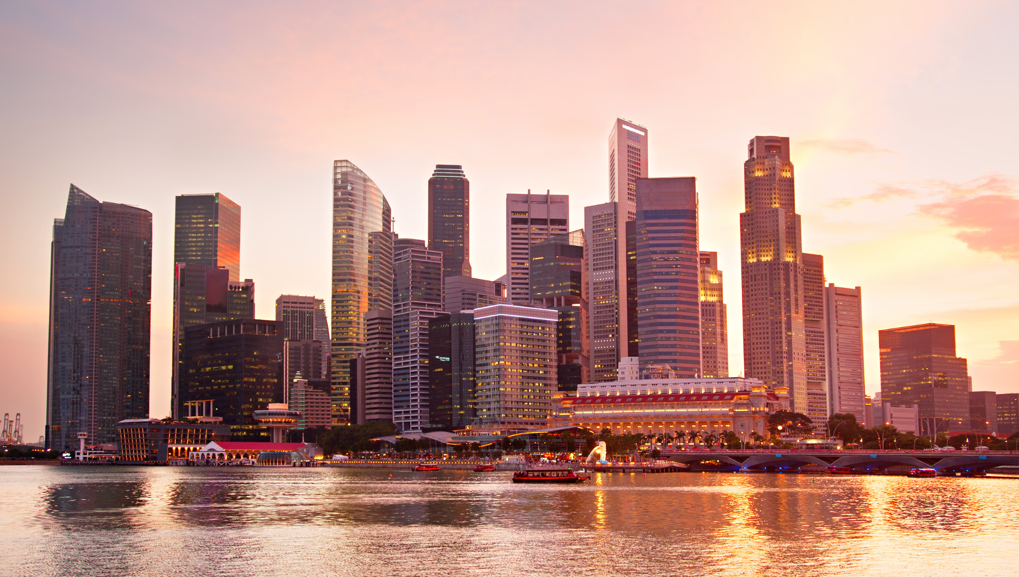 Skyline of a modern city with high-rise buildings at sunset, related to offering memorandums.