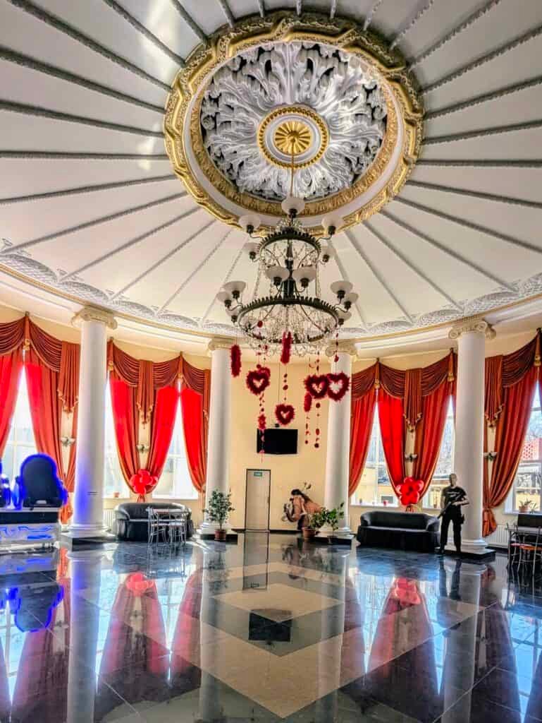 gorky cinema Bender Transnistria inside. Ornate with chandeliers and gold, with statement red velvet curtains. Circular entrance hall.