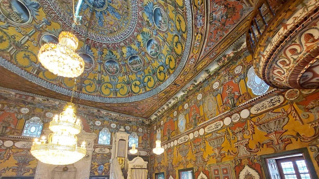 Visit the painted mosque in Tetovo inside tetovo painted mosque with its chandeliers, painted celings, balcones and wllas. Painted in many colours with ochre as the base colour.